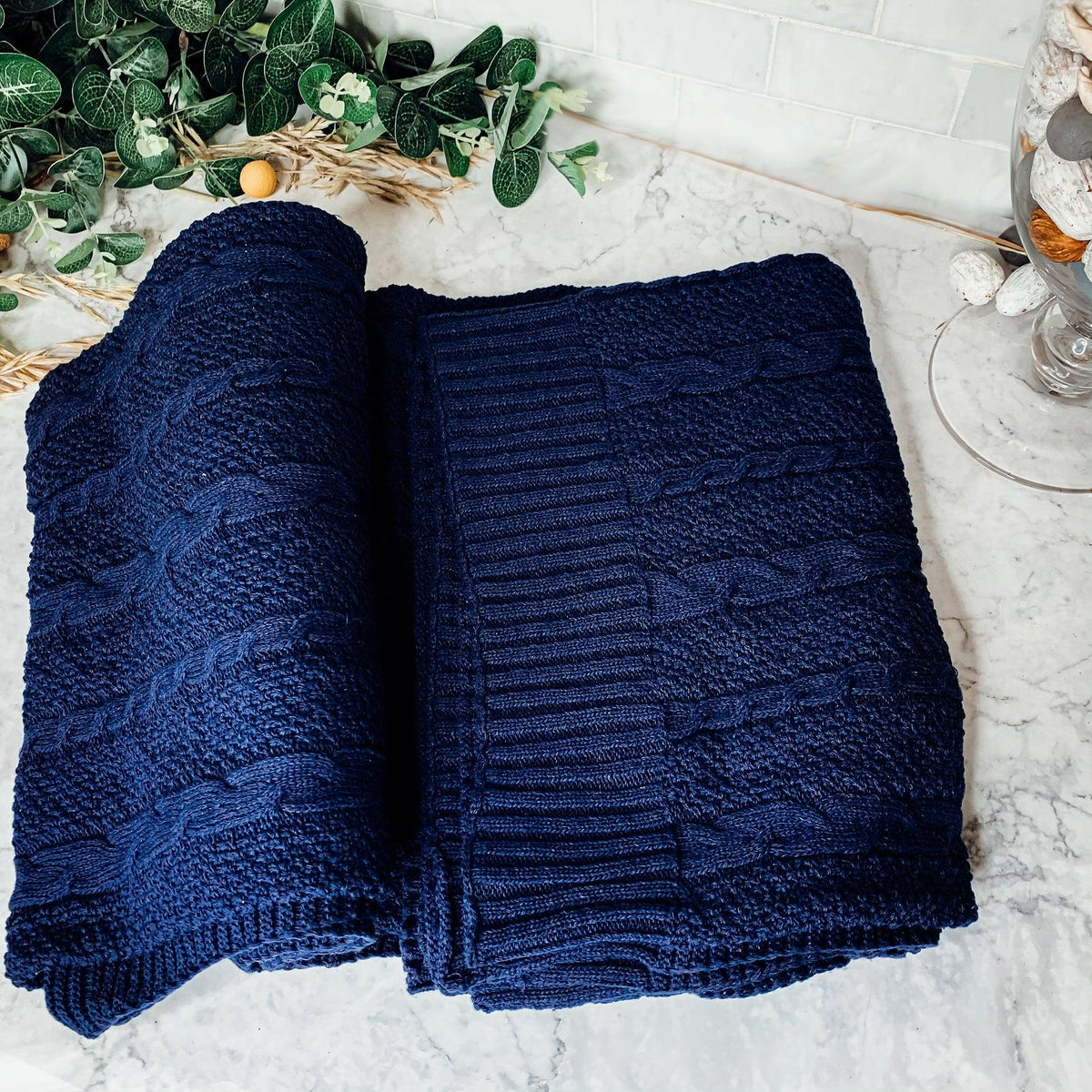 Claret Cotton-Blend Cable-Knit Throw: Blue cable-knit throw spread on a light surface.