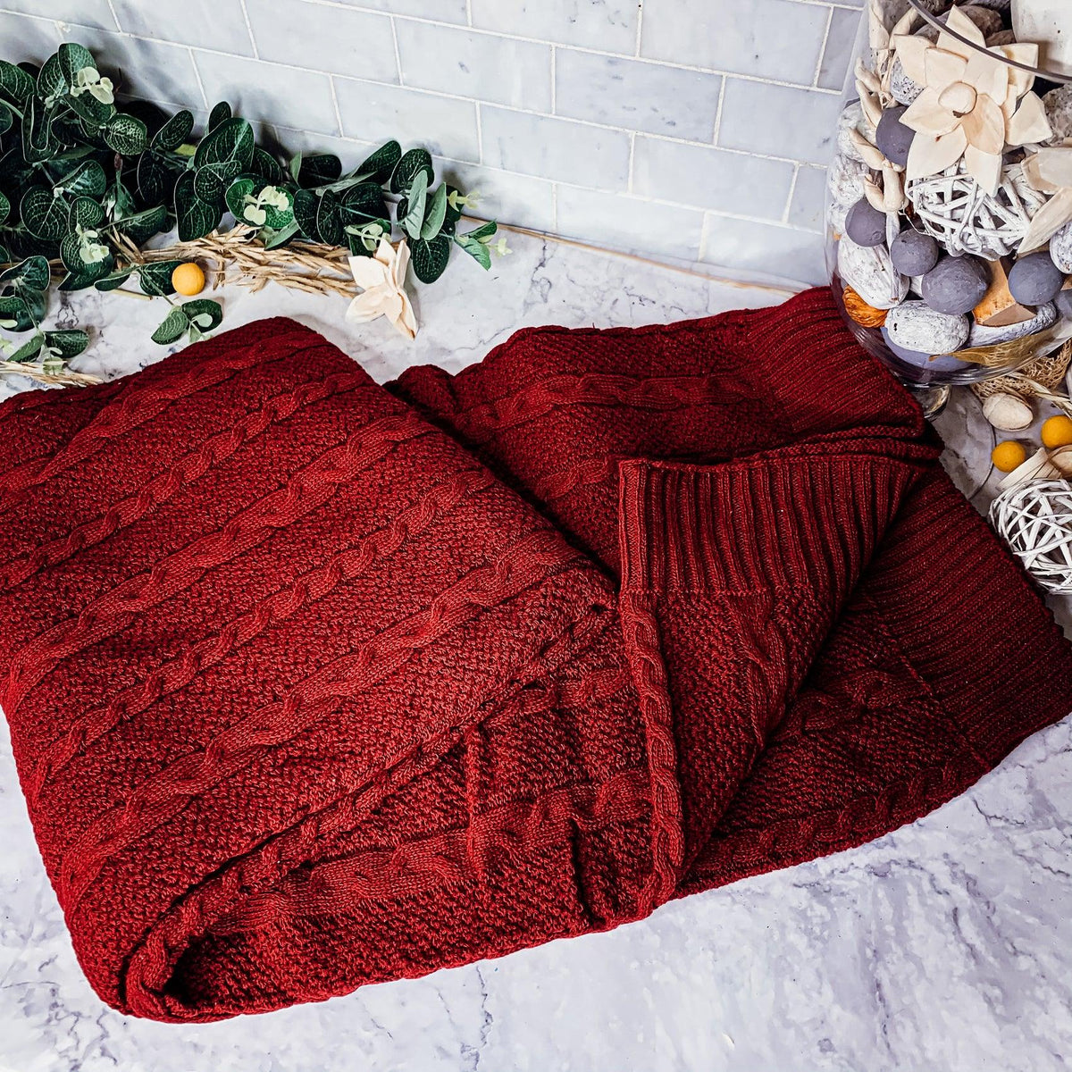 Claret Cotton-Blend Cable-Knit Throw: Red cable-knit throw spread on a light surface.